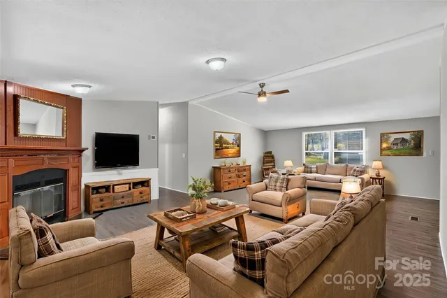 a living room with fireplace furniture and a flat screen tv