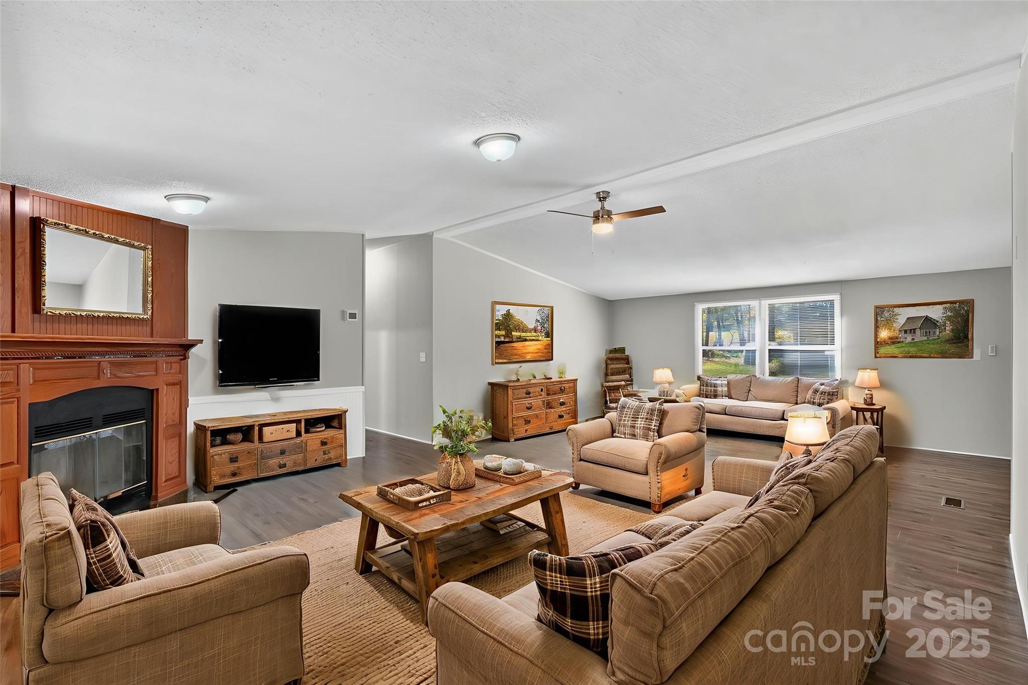 3802 Hickory Grove Road Mount Holly, NC 28120 - Photo 3 of 15 a living room with fireplace furniture and a flat screen tv