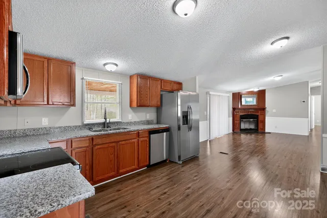 a kitchen with stainless steel appliances granite countertop a sink and cabinets