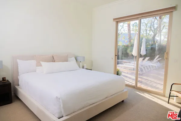 a white toilet sitting next to a bathroom sink and a window