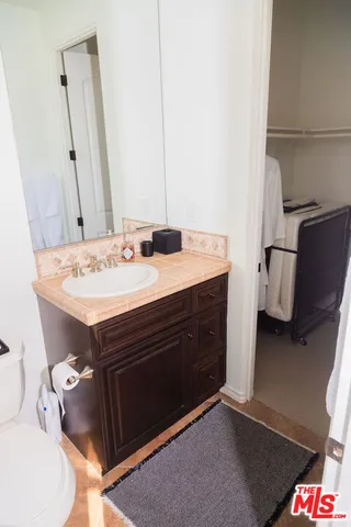 a large bed sitting in a bedroom next to a lamp