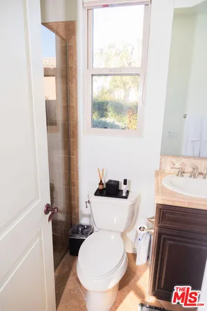 a bedroom with a bed and a night stand