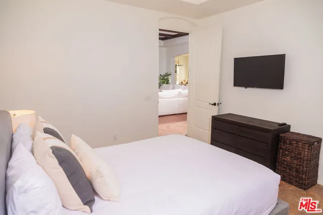 a bedroom with a bed and a large window