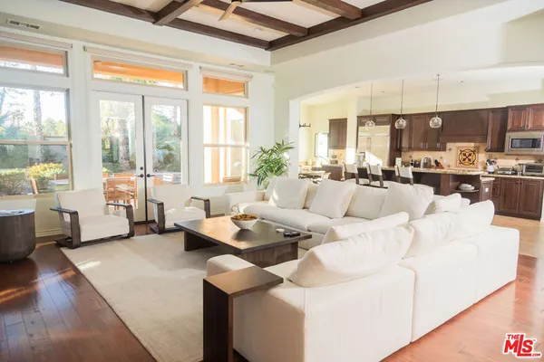 a living room with furniture and a floor to ceiling window