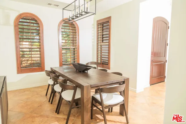 a view of a dining room with furniture and a window