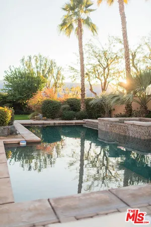 a outdoor living space with patio furniture and a lake view