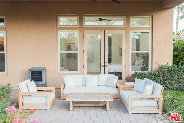 a view of a patio with dining table and chairs with potted plants
