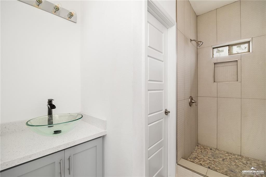 2105 Azalea Street Mission, TX 78573 - Photo 11 of 14 a bathroom with a sink and a mirror