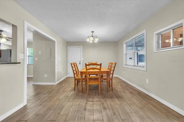 a kitchen with stainless steel appliances granite countertop a refrigerator a sink dishwasher a stove with white cabinets