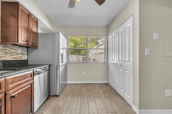 a view of an empty room with a ceiling fan