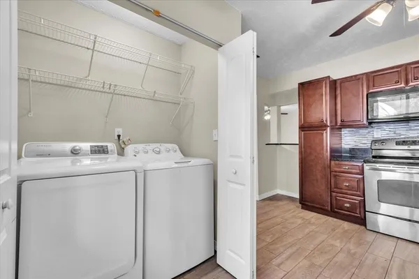a bathroom with a granite countertop toilet a sink and a mirror