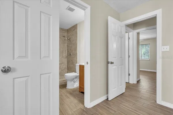 a view of an empty room with wooden floor