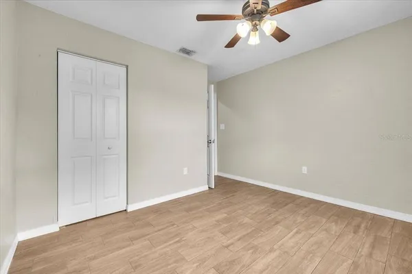 a view of a room with window wooden floor and front door