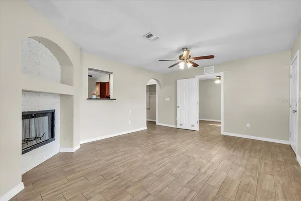 a view of a hallway with wooden floor