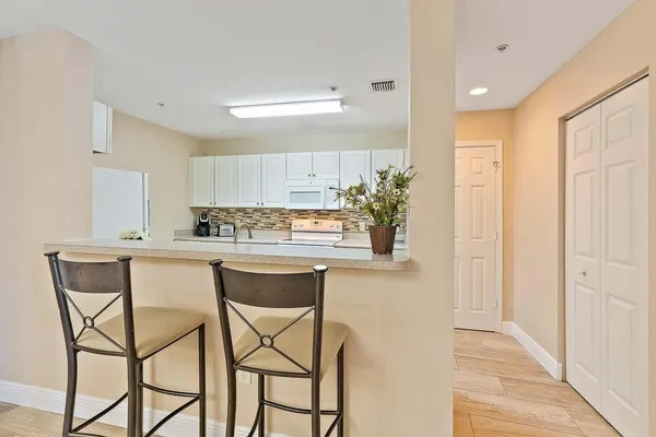 a kitchen with a table and chairs in it