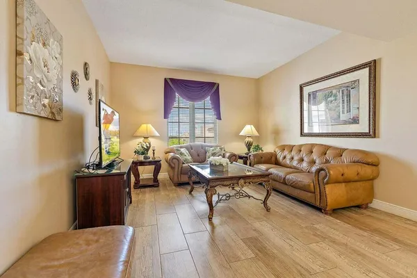 a living room with furniture and wall painting