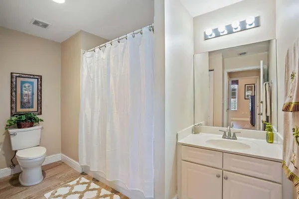 a bathroom with a toilet a sink and a mirror