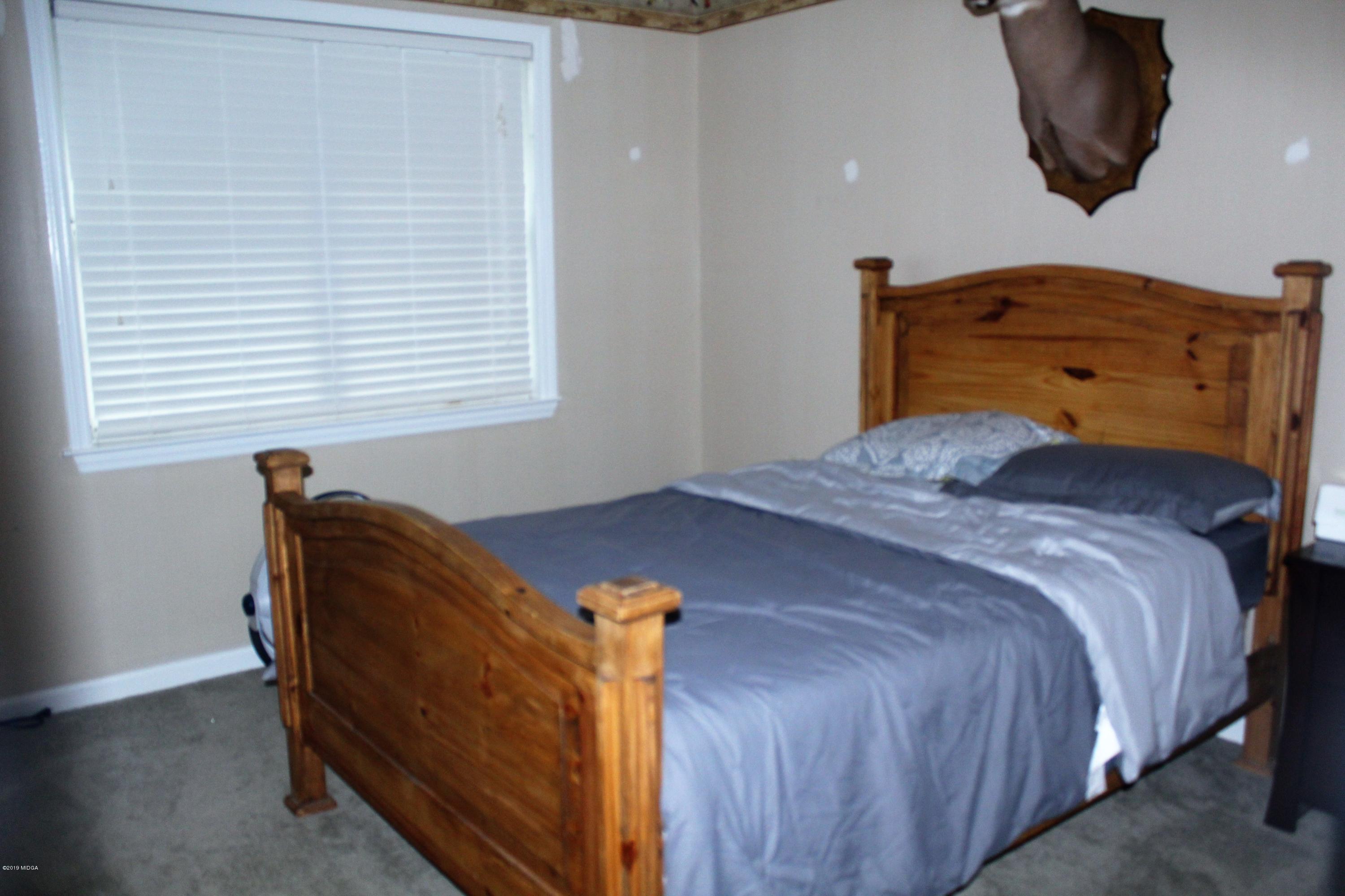 139 Bone Creek Road Macon, GA 31211 - Photo 11 of 18 a bedroom with a bed and window