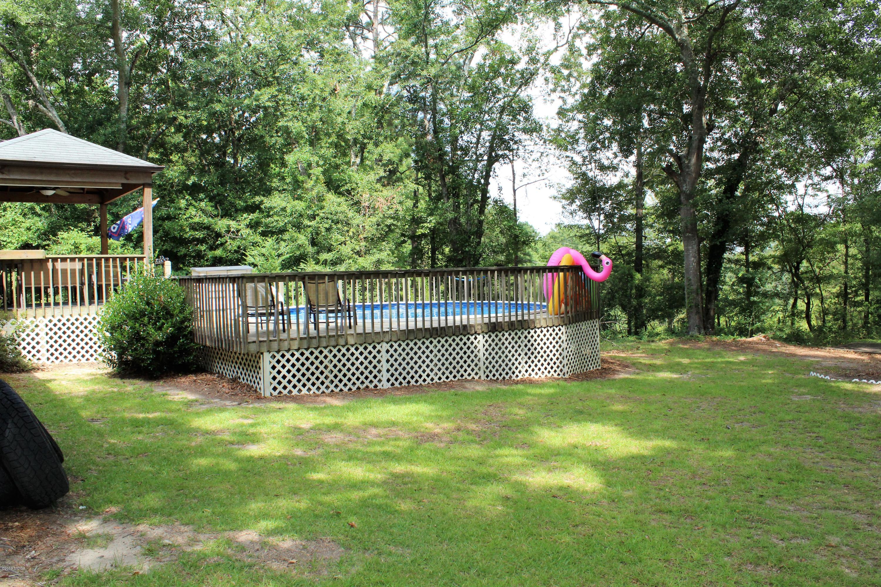 139 Bone Creek Road Macon, GA 31211 - Photo 16 of 18 a view of a garden with wooden fence and a bench