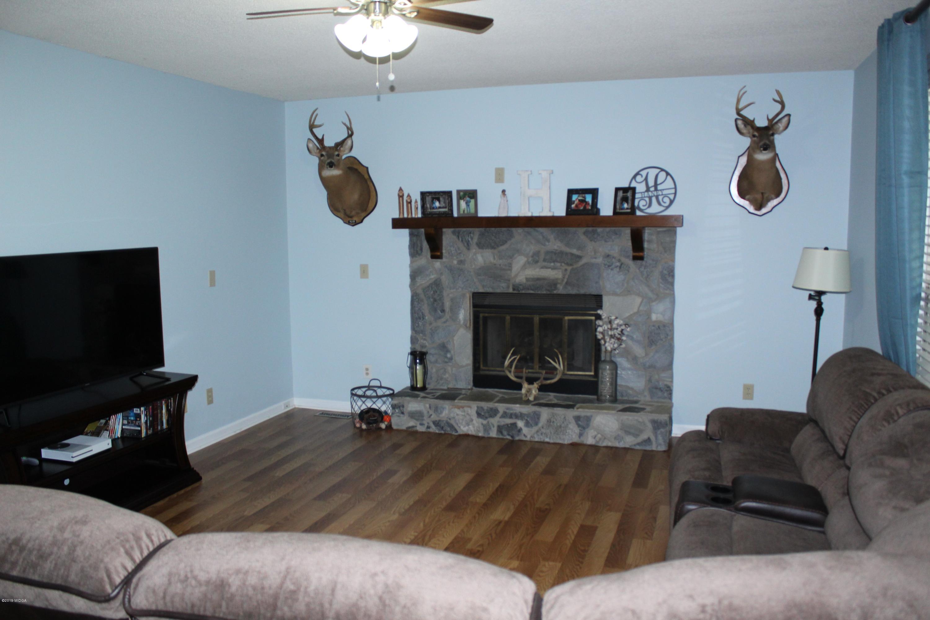 139 Bone Creek Road Macon, GA 31211 - Photo 3 of 18 a living room with furniture and a fireplace