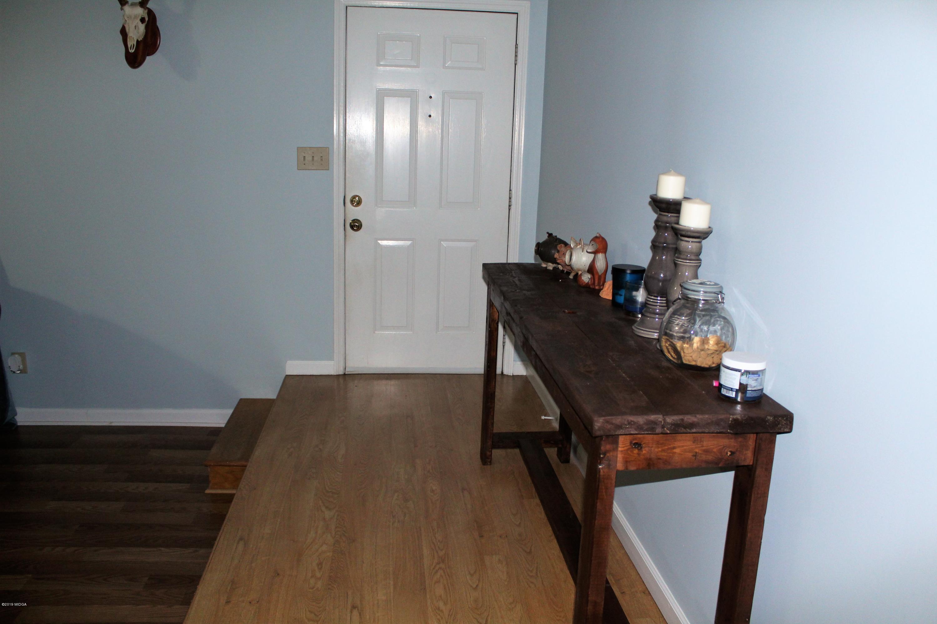 139 Bone Creek Road Macon, GA 31211 - Photo 5 of 18 a view of a workspace with furniture and wooden floor