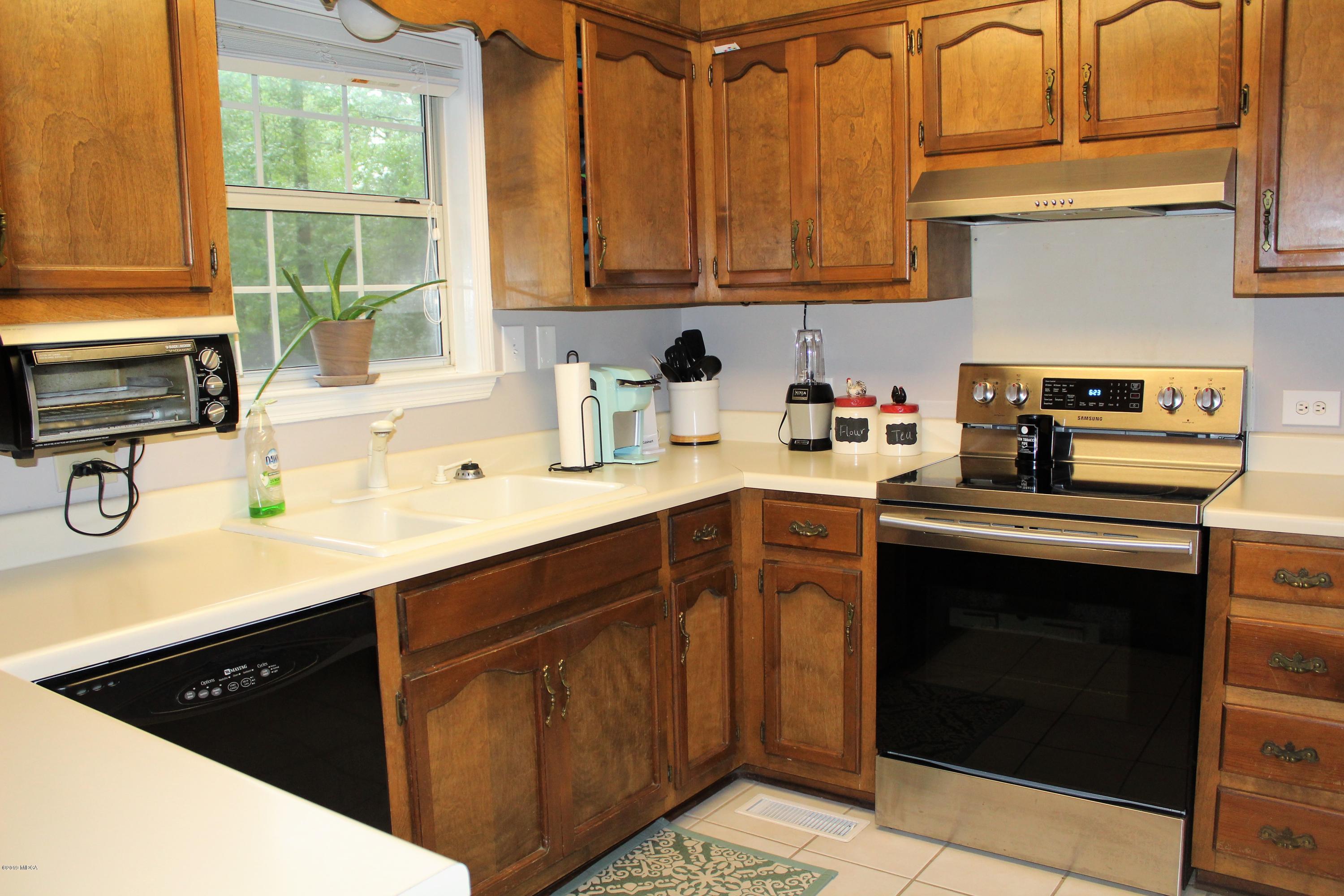 139 Bone Creek Road Macon, GA 31211 - Photo 7 of 18 a kitchen with a sink stove and cabinets
