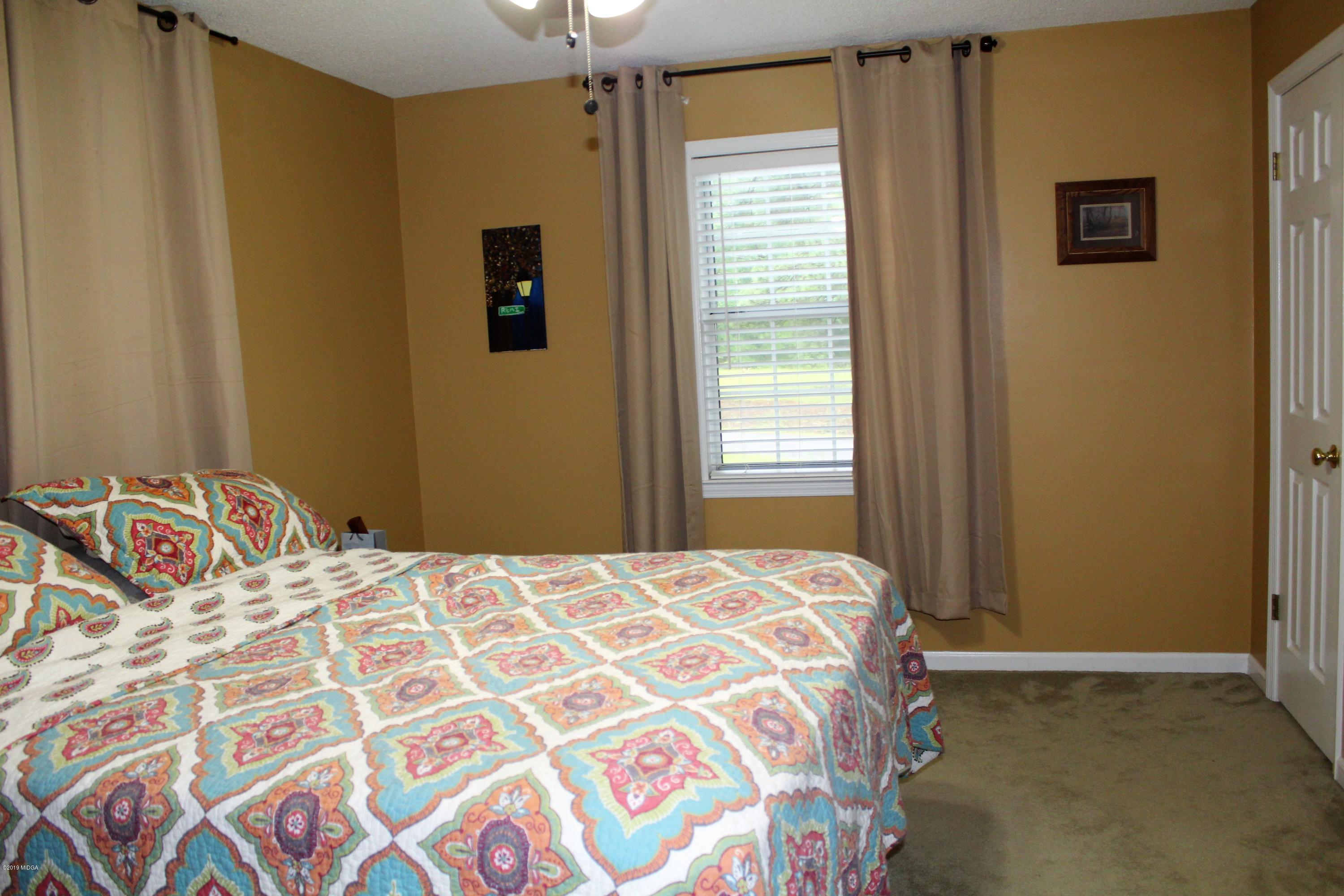 139 Bone Creek Road Macon, GA 31211 - Photo 9 of 18 a bedroom with a bed and a window