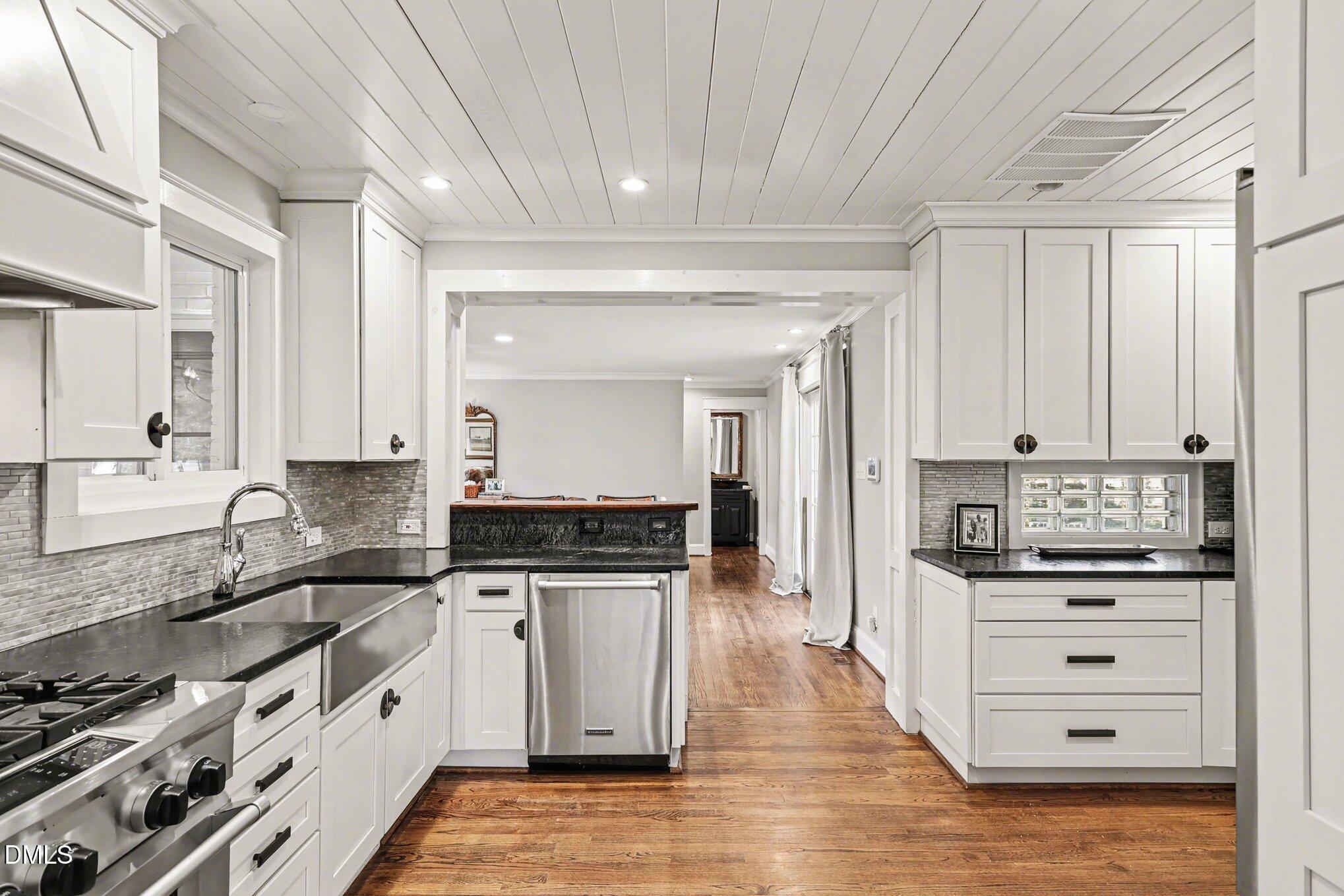 227 Furches Street Raleigh, NC 27607 - Photo 11 of 26 a kitchen with granite countertop a sink and cabinets