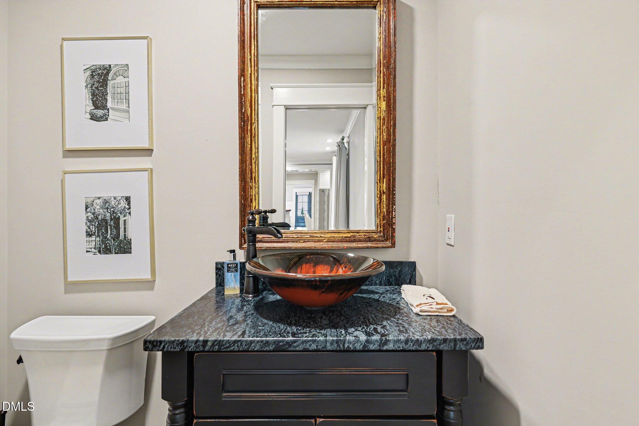 227 Furches Street Raleigh, NC 27607 - Photo 14 of 26 a bathroom with a granite countertop sink and a mirror
