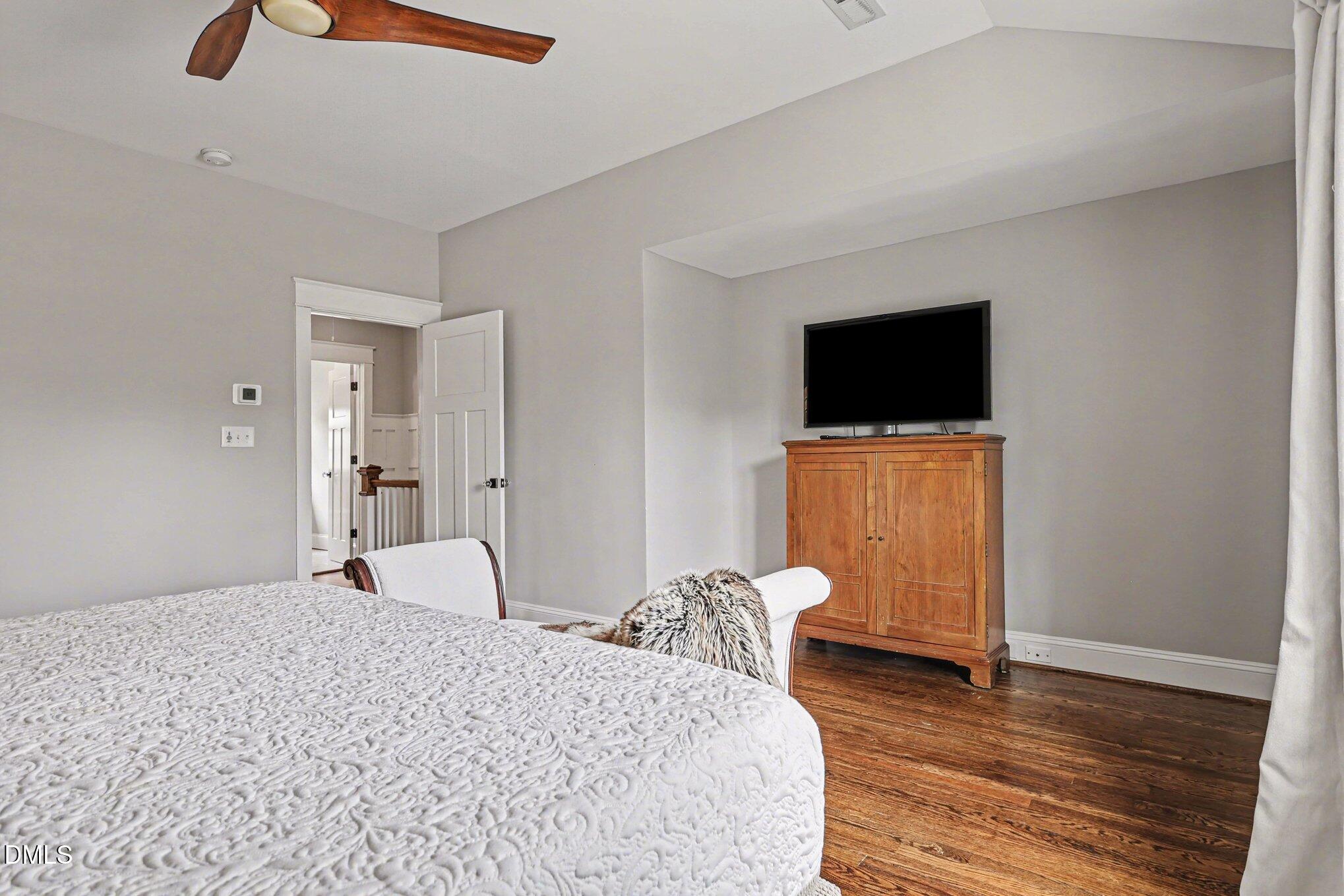 227 Furches Street Raleigh, NC 27607 - Photo 16 of 26 a bedroom with a bed and a television