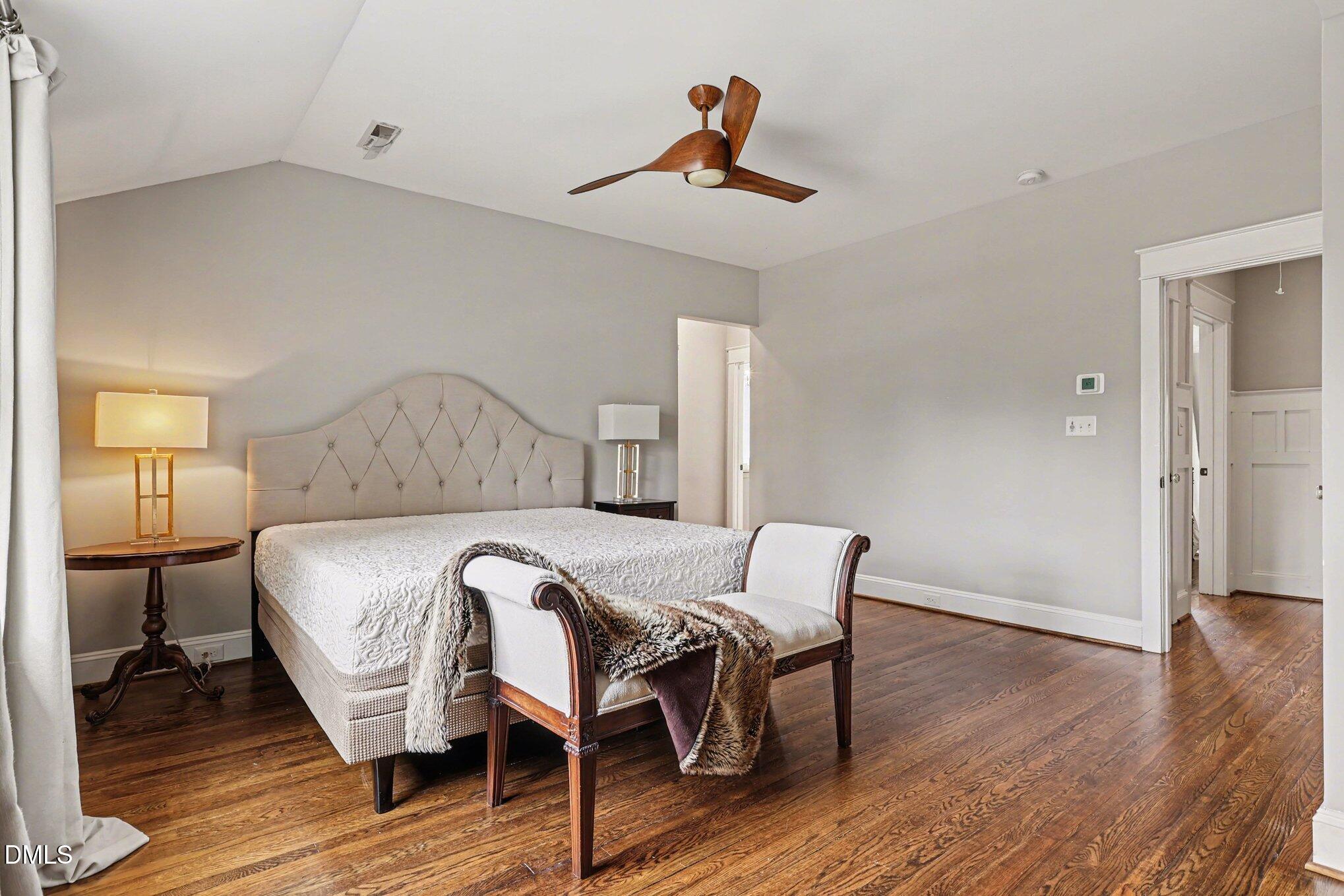 227 Furches Street Raleigh, NC 27607 - Photo 17 of 26 a bedroom with a bed and wooden floor