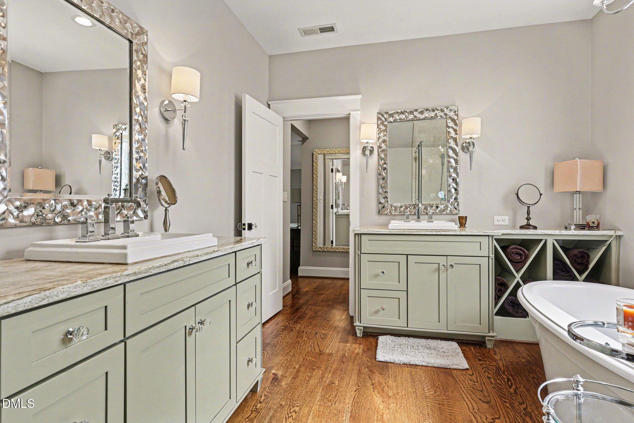 227 Furches Street Raleigh, NC 27607 - Photo 21 of 26 a spacious bathroom with a granite countertop sink a toilet a mirror and vanity