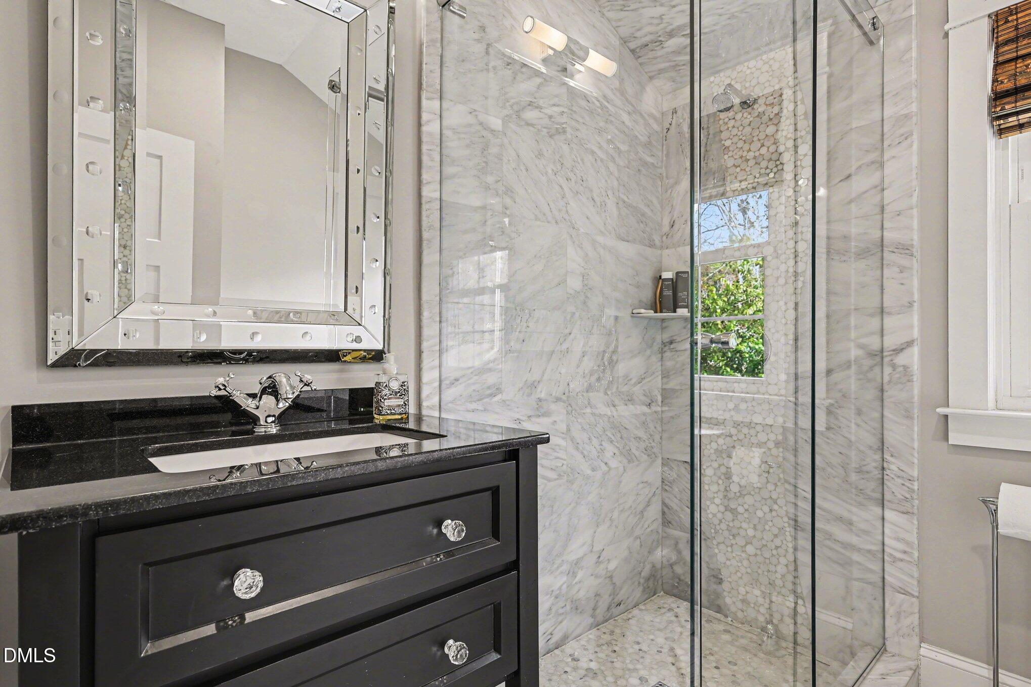 227 Furches Street Raleigh, NC 27607 - Photo 23 of 26 a bathroom with a granite countertop sink a mirror and shower