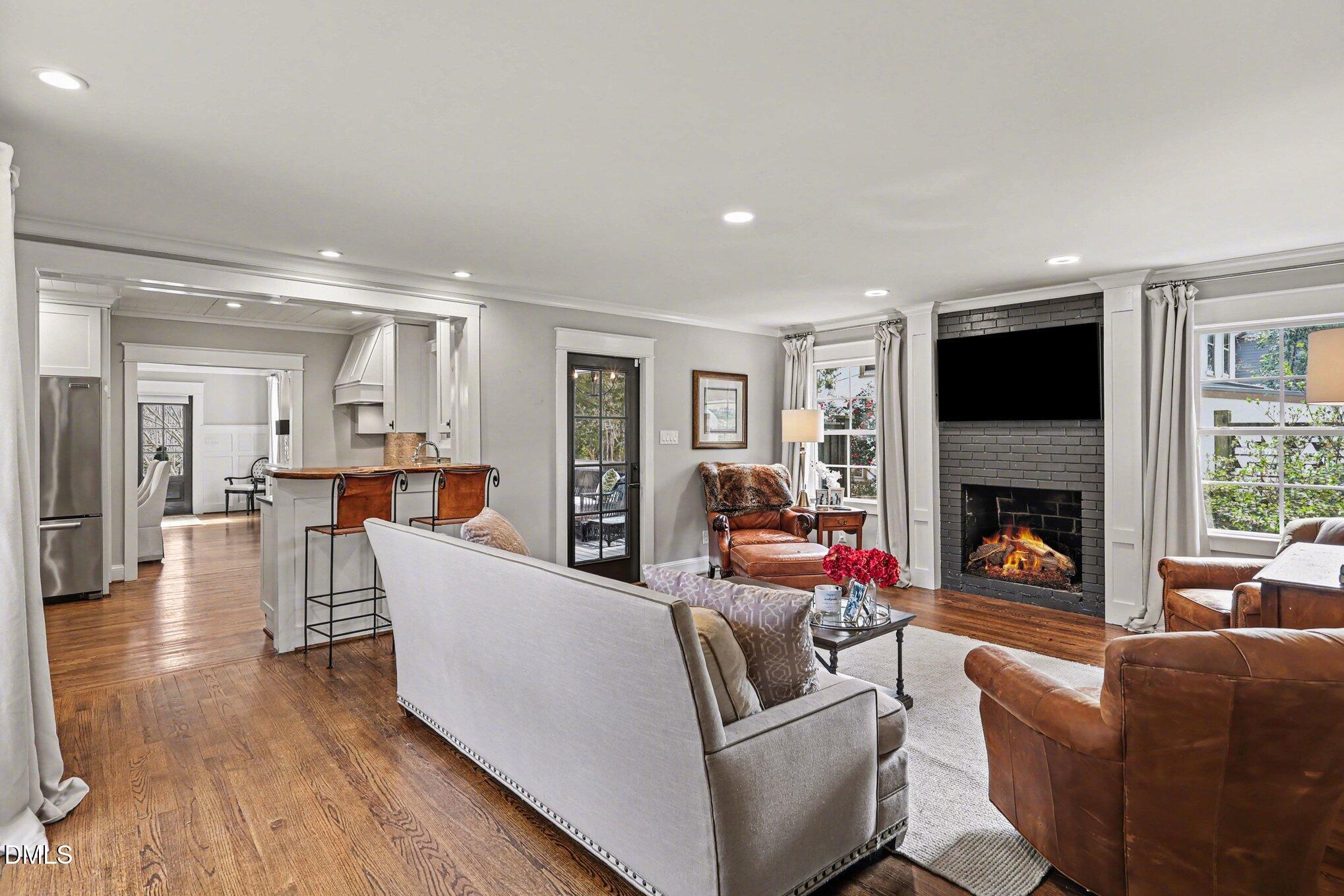 227 Furches Street Raleigh, NC 27607 - Photo 7 of 26 a living room with fireplace furniture and a flat screen tv