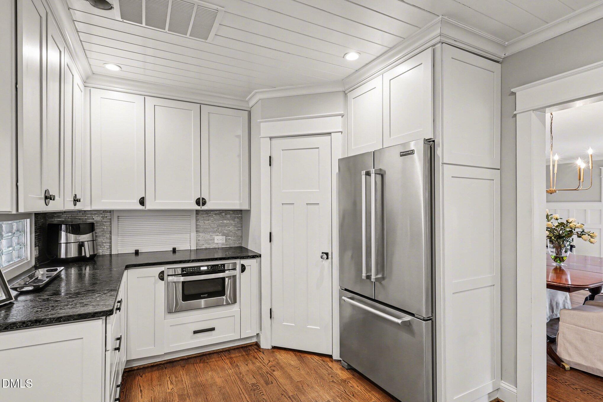 227 Furches Street Raleigh, NC 27607 - Photo 10 of 26 a kitchen with cabinets and stainless steel appliances