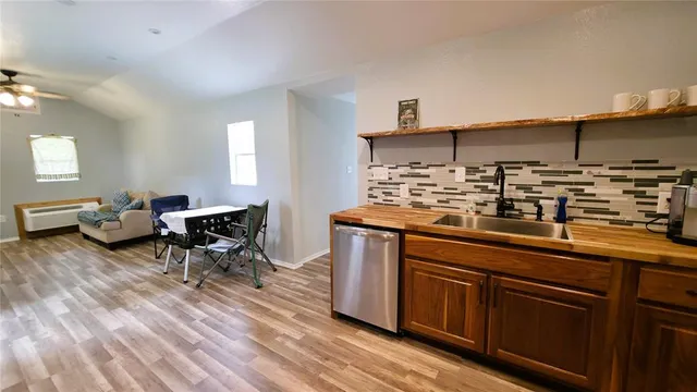a kitchen with sink cabinets and wooden floor