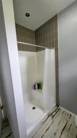 a bathroom with a tub and shower