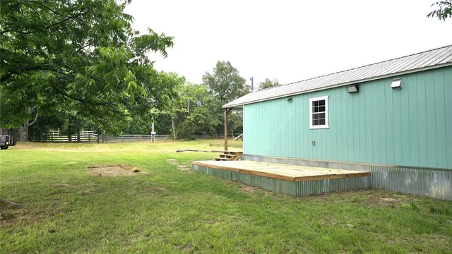 a view of a house with a backyard