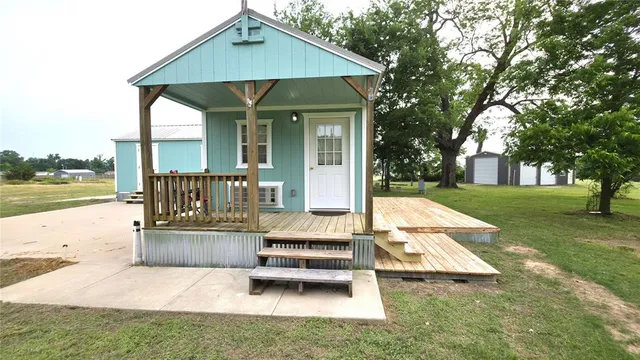 a view of a house with backyard and sitting area