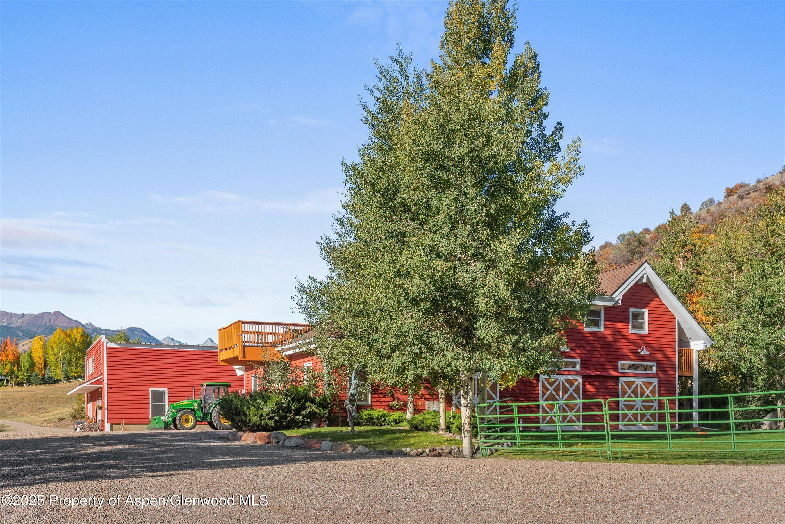 660 Brush Creek Road Aspen, CO 81611 - Photo 12 of 27 a front view of a house with a yard and trees