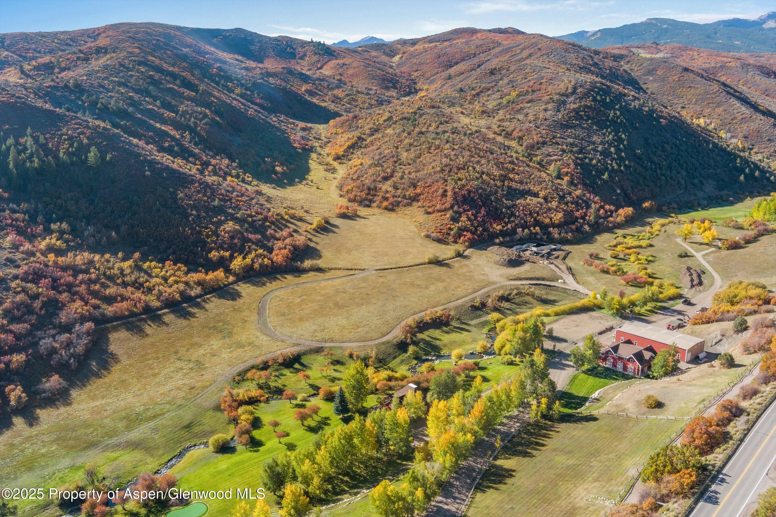 660 Brush Creek Road Aspen, CO 81611 - Photo 16 of 27 a view of a yard with a mountain