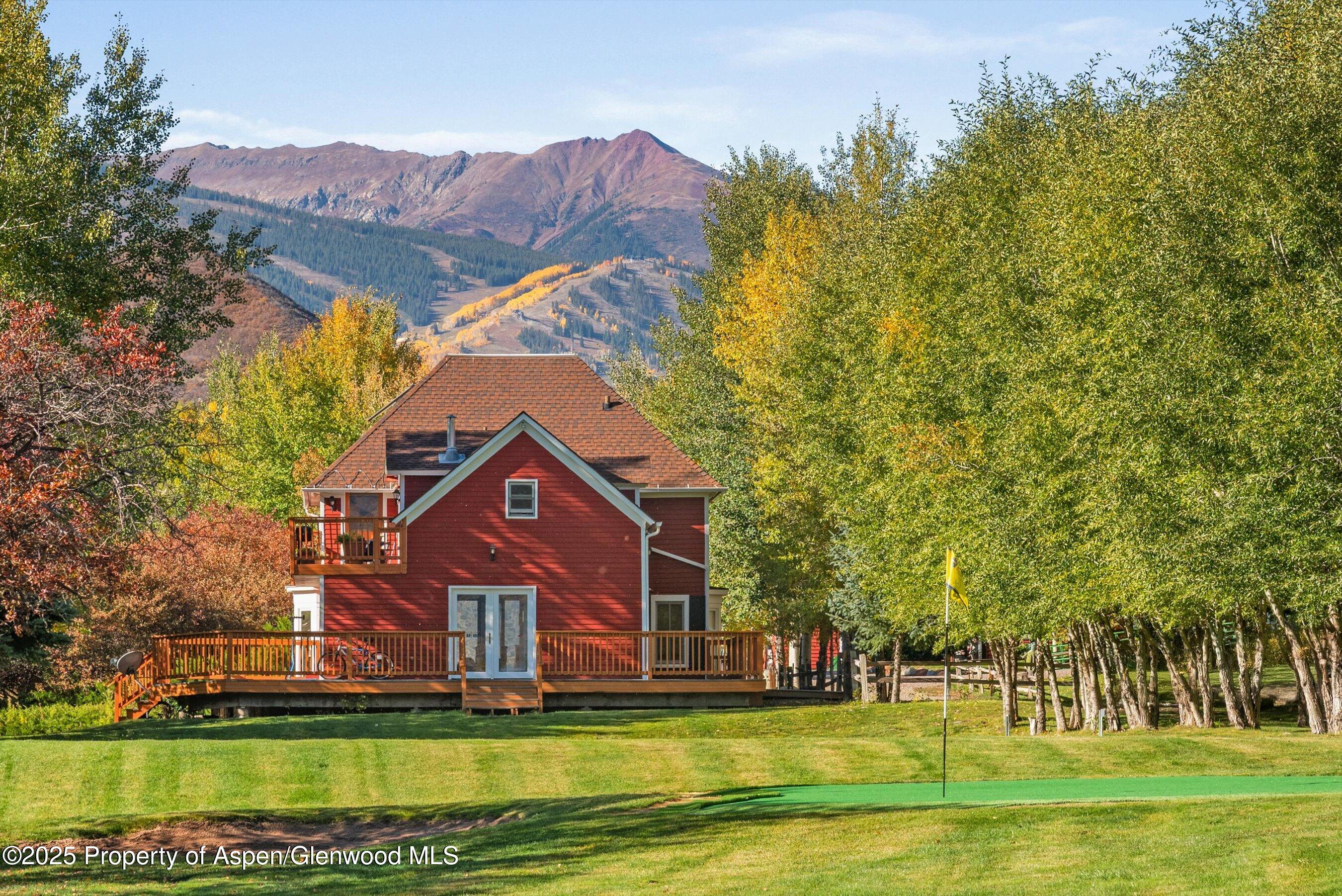 660 Brush Creek Road Aspen, CO 81611 - Photo 8 of 27 a front view of a house with a garden and a yard