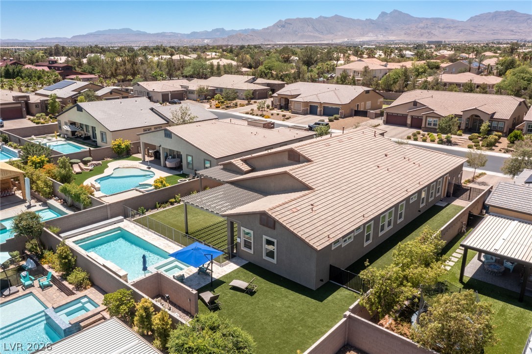 7036 Arabian Ridge Street Las Vegas, NV 89131 - Photo 6 of 64 Aerial view of this single story on it's sprawling lot with plenty of covered patio and pergola space to help keep cool on those hot summer days and a sparkling pool and spa!
