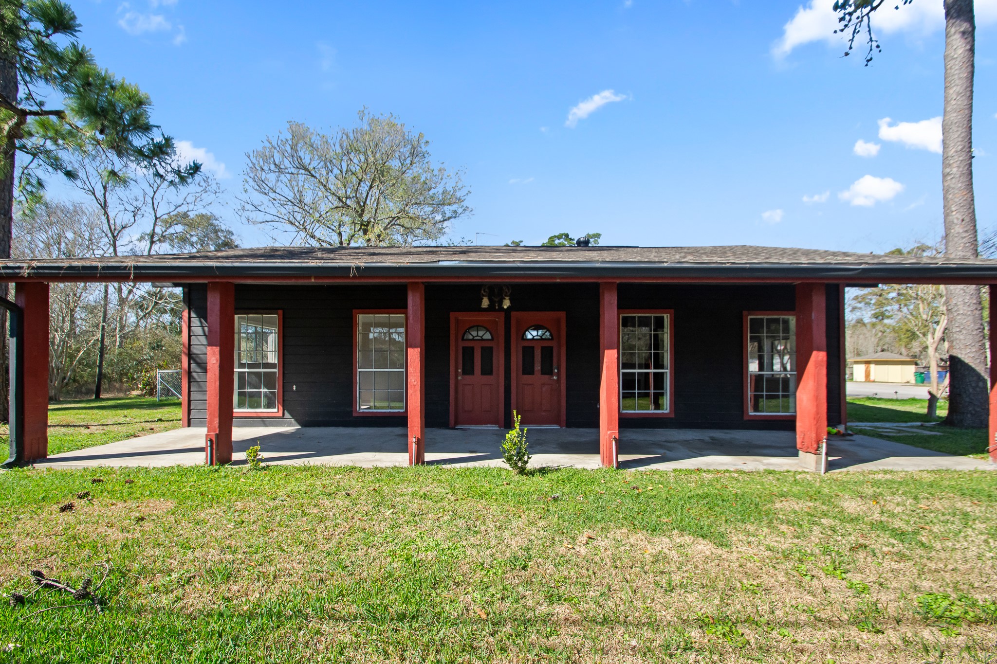 6830 South Highway 35 Alvin, TX 77511 - Photo 1 of 24 a view of a house with a porch and floor to ceiling window