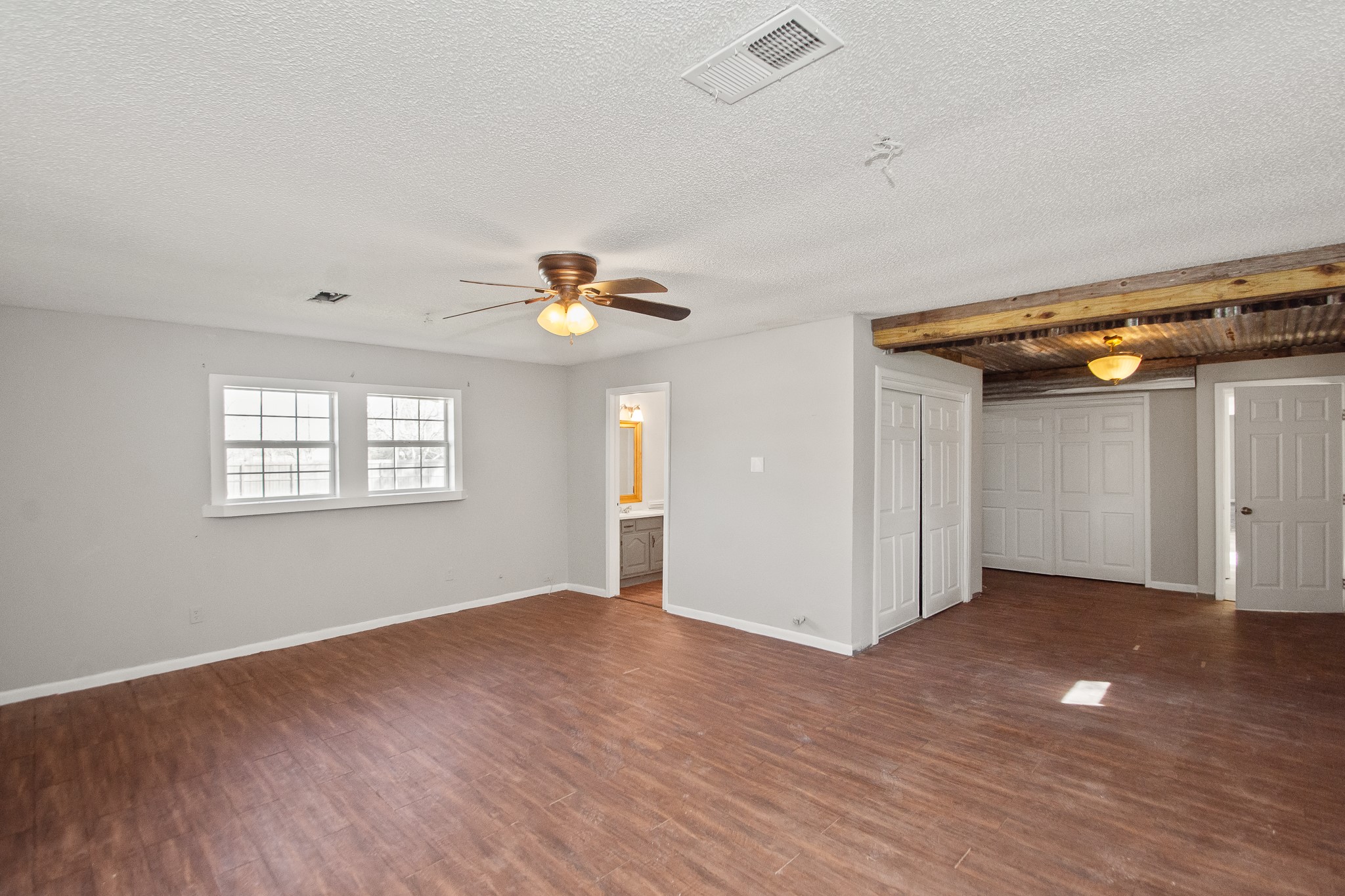 6830 South Highway 35 Alvin, TX 77511 - Photo 11 of 24 an empty room with wooden floor and windows