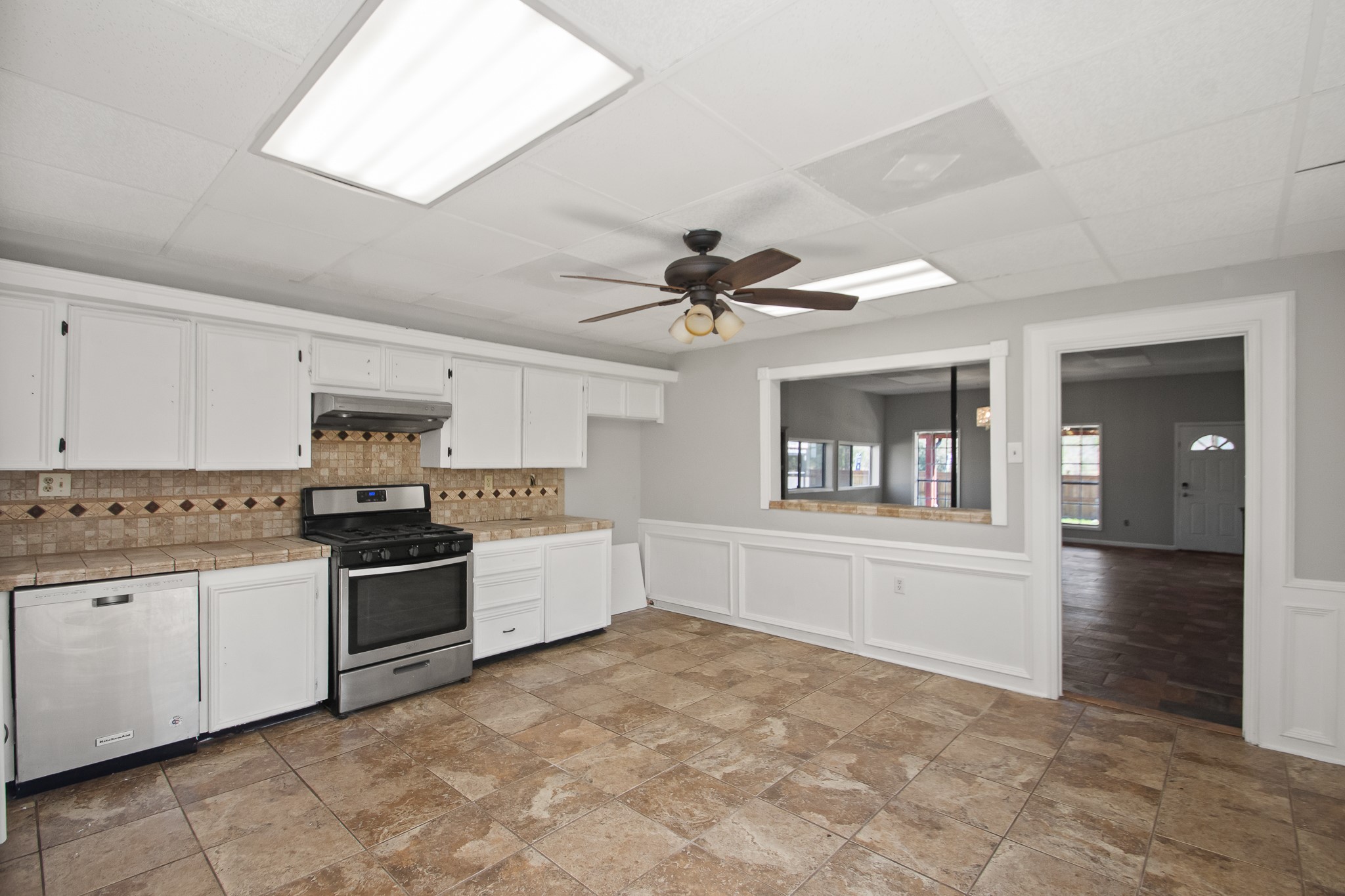 6830 South Highway 35 Alvin, TX 77511 - Photo 13 of 24 a kitchen with granite countertop a stove top oven and cabinets