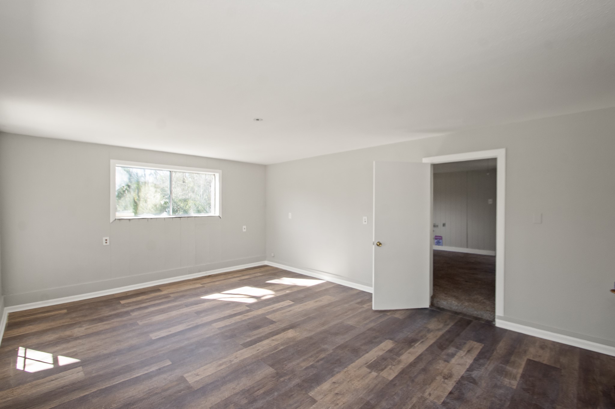6830 South Highway 35 Alvin, TX 77511 - Photo 16 of 24 a view of an empty room with wooden floor and a window