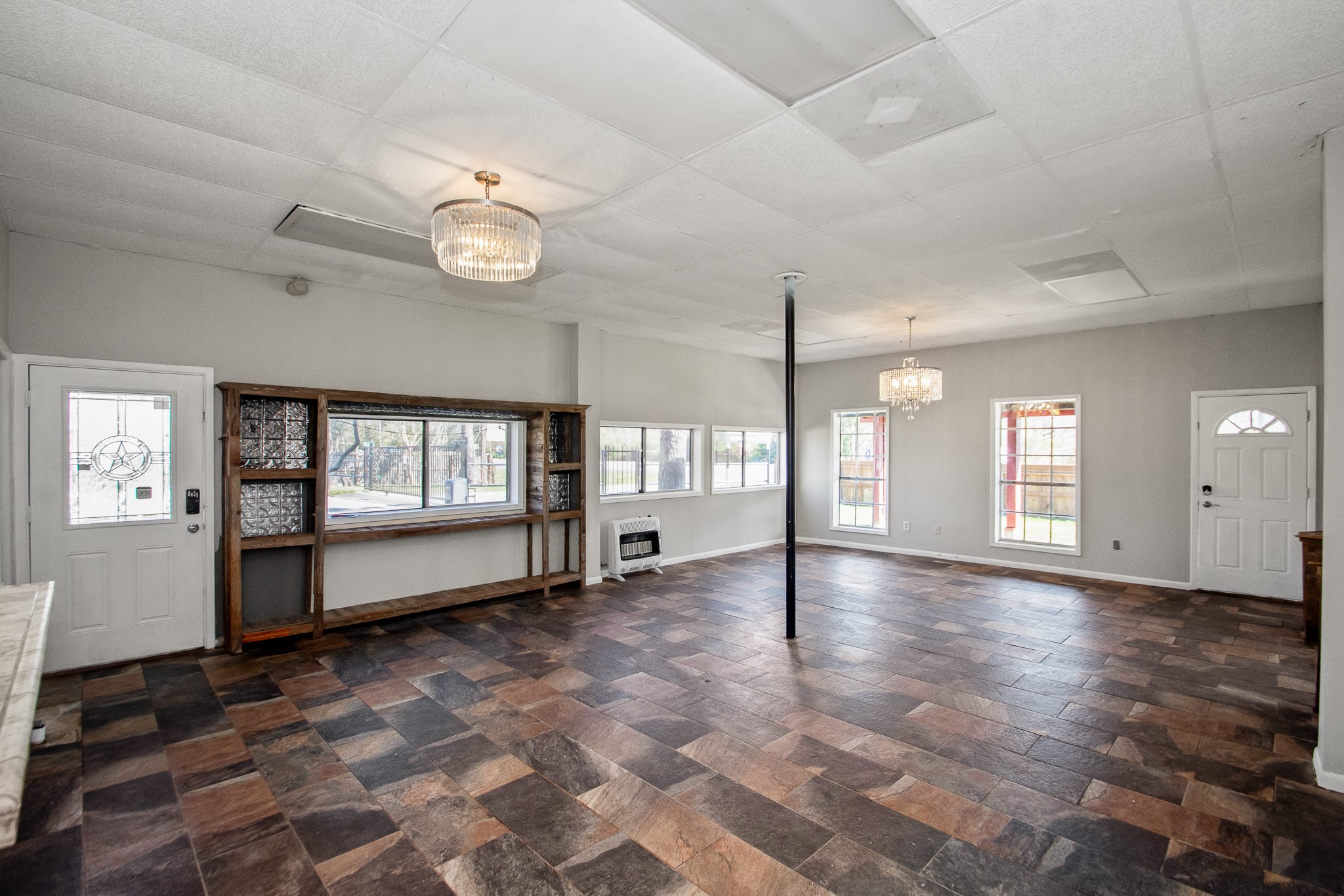 6830 South Highway 35 Alvin, TX 77511 - Photo 19 of 24 a view of an empty room with a window and wooden floor