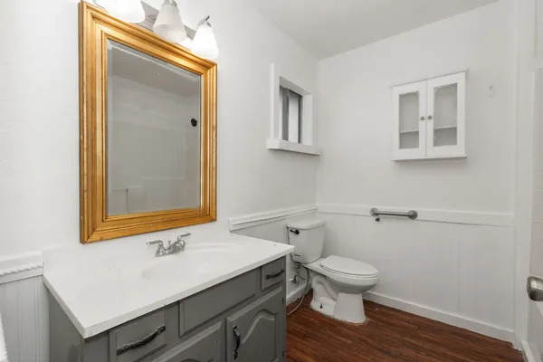 a bathroom with a sink a toilet and mirror