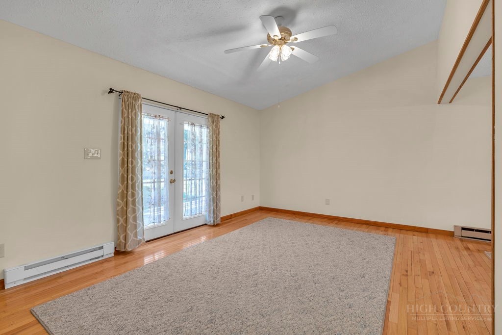 163 Rolling Hill Drive Boone, NC 28607 - Photo 10 of 40 an empty room with chandelier fan and windows